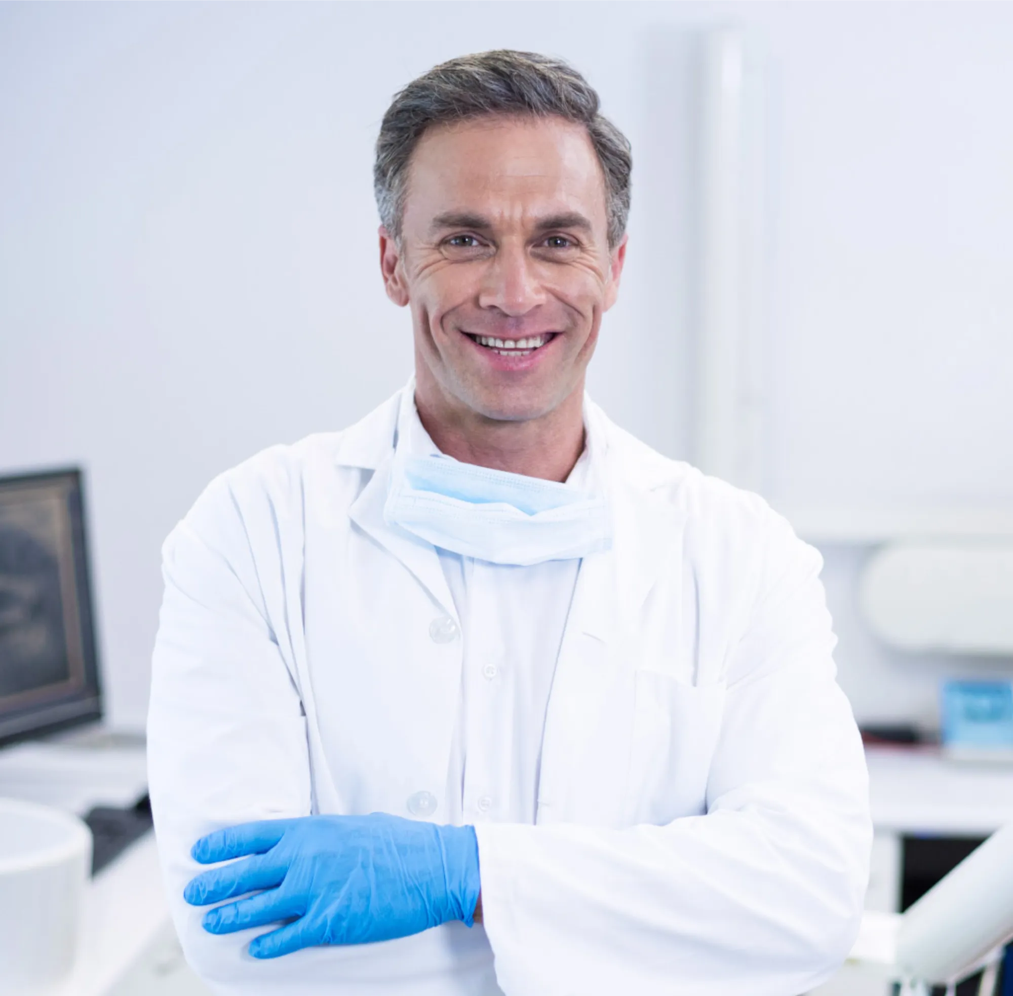 Smiling dentist standing with arms crossed p55snte 1
